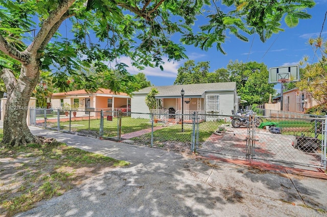 100 SW 67th Ct, Miami, FL 33144 - view of front of house featuring a gate, a fenced front yard, and stucco siding