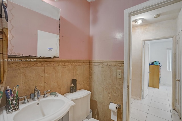 100 SW 67th Ct, Miami, FL 33144 - bathroom featuring tile patterned flooring, tile walls, and wainscoting