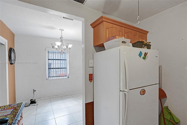 100 SW 67th Ct, Miami, FL 33144 - kitchen with freestanding refrigerator, a chandelier, light tile patterned flooring, and pendant lighting