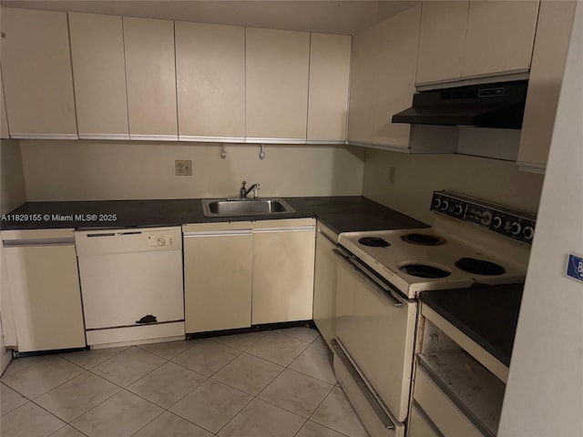 2500 Parkview Dr Unit 312, Hallandale Beach, FL 33009 - kitchen with white appliances, under cabinet range hood, dark countertops, and light tile patterned flooring