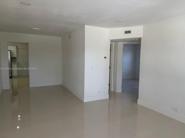 1494 W 34th St, Riviera Beach, FL 33404 - unfurnished room featuring baseboards and light tile patterned flooring