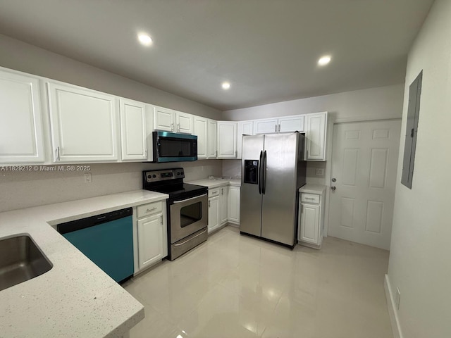 1494 W 34th St, Riviera Beach, FL 33404 - kitchen featuring appliances with stainless steel finishes, white cabinets, recessed lighting, electric panel, and light stone countertops