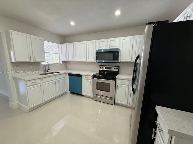 1494 W 34th St, Riviera Beach, FL 33404 - kitchen featuring appliances with stainless steel finishes, white cabinetry, light countertops, and recessed lighting
