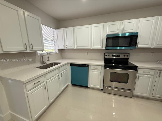 1494 W 34th St, Riviera Beach, FL 33404 - kitchen with appliances with stainless steel finishes, white cabinetry, and light countertops