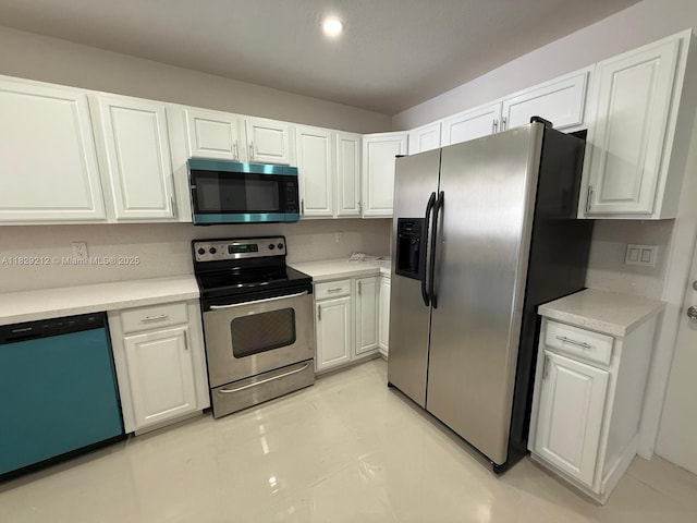 1494 W 34th St, Riviera Beach, FL 33404 - kitchen featuring appliances with stainless steel finishes, white cabinets, and light countertops