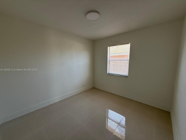 1494 W 34th St, Riviera Beach, FL 33404 - spare room with light tile patterned flooring and baseboards