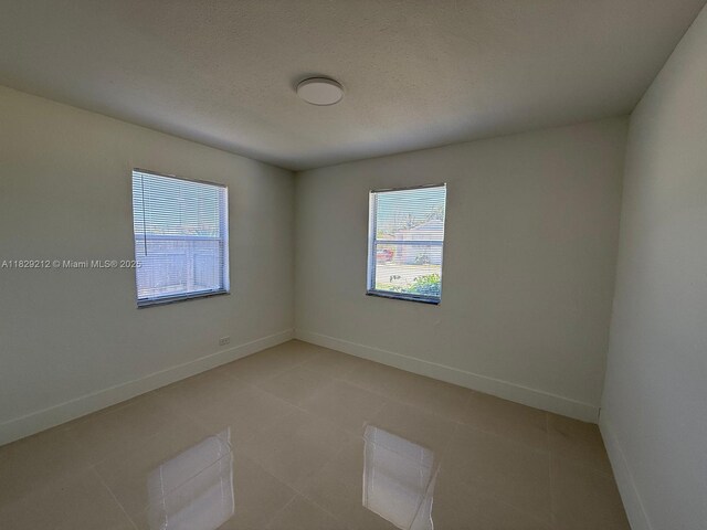 1494 W 34th St, Riviera Beach, FL 33404 - empty room with light tile patterned floors