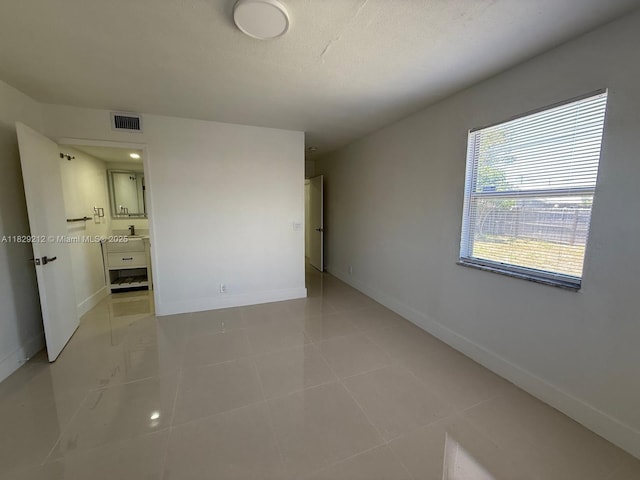 1494 W 34th St, Riviera Beach, FL 33404 - empty room with baseboards and light tile patterned floors