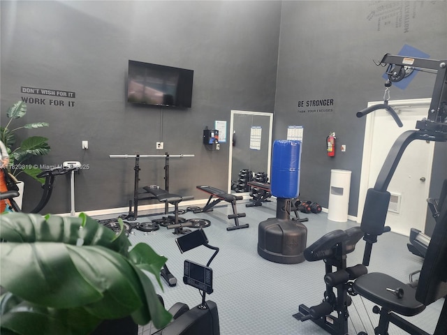 2541 Aragon Blvd Unit 105, Sunrise, FL 33322 - workout area featuring a high ceiling and baseboards
