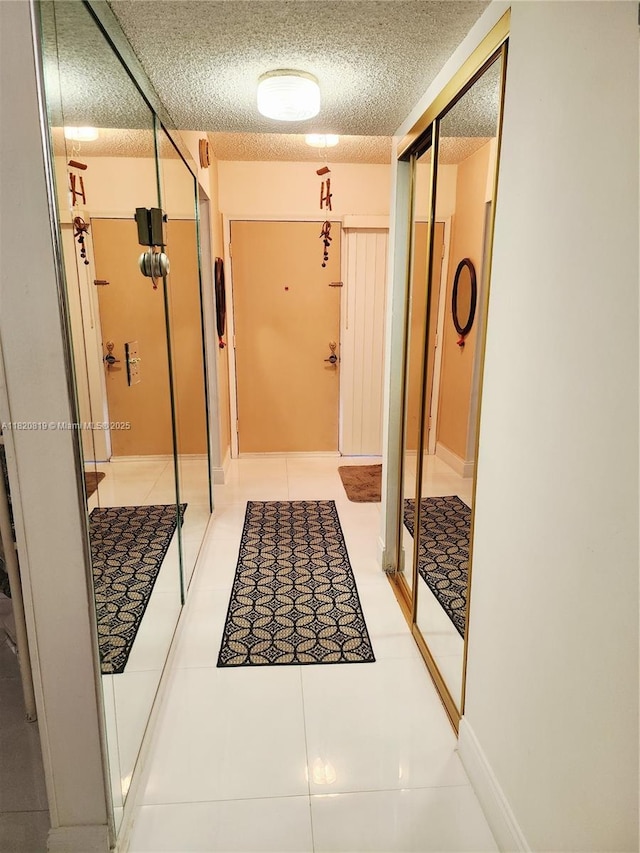 2541 Aragon Blvd Unit 105, Sunrise, FL 33322 - corridor featuring a textured ceiling and light tile patterned floors