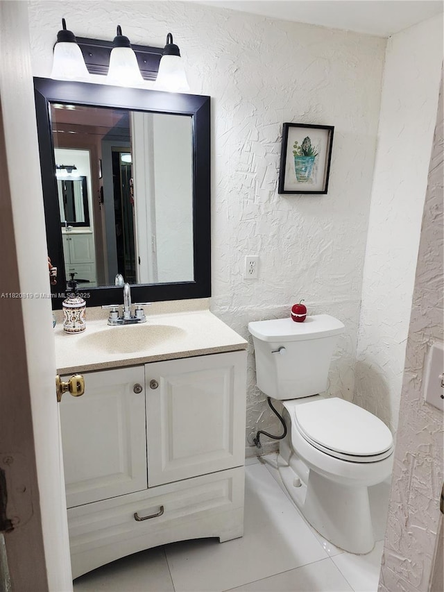 2541 Aragon Blvd Unit 105, Sunrise, FL 33322 - half bath with tile patterned floors, vanity, and a textured wall