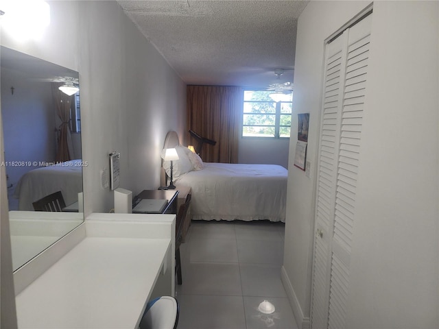 2541 Aragon Blvd Unit 105, Sunrise, FL 33322 - bedroom featuring tile patterned flooring, a textured ceiling, and a closet