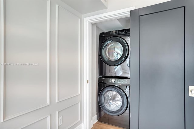 1145 SW 20th Ave, Miami, FL 33135 - laundry room with stacked washer and clothes dryer and light wood finished floors