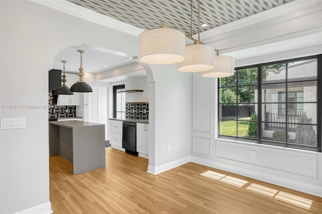 1145 SW 20th Ave, Miami, FL 33135 - kitchen featuring arched walkways, black dishwasher, light wood finished floors, decorative light fixtures, and white cabinets