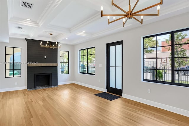 1145 SW 20th Ave, Miami, FL 33135 - unfurnished living room featuring a chandelier, light wood-style flooring, coffered ceiling, beam ceiling, and crown molding