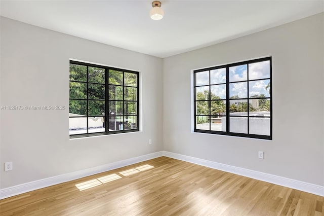 1145 SW 20th Ave, Miami, FL 33135 - spare room with light wood-style floors and healthy amount of natural light