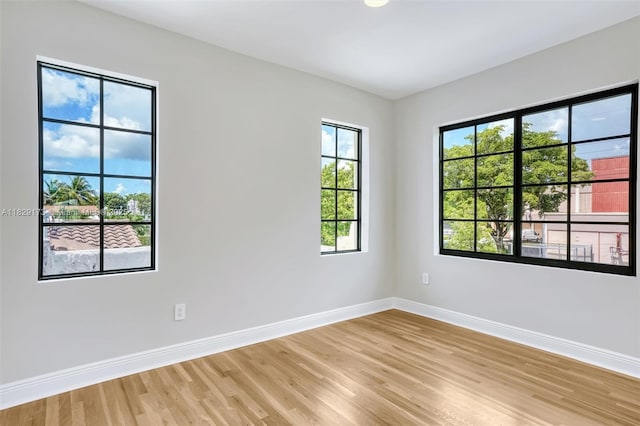 1145 SW 20th Ave, Miami, FL 33135 - unfurnished room featuring light wood-type flooring and plenty of natural light