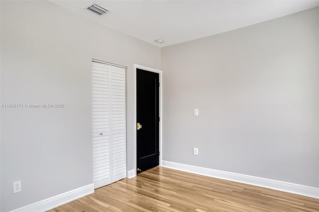 1145 SW 20th Ave, Miami, FL 33135 - unfurnished bedroom with light wood-style flooring and a closet