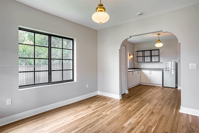 1145 SW 20th Ave, Miami, FL 33135 - unfurnished room featuring arched walkways and light wood-type flooring