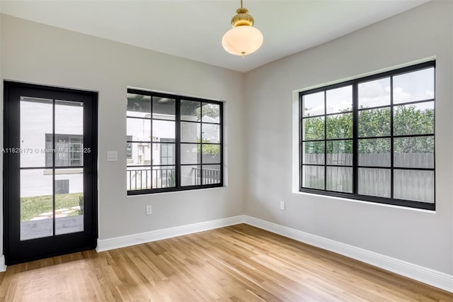 1145 SW 20th Ave, Miami, FL 33135 - empty room with light wood finished floors and healthy amount of natural light