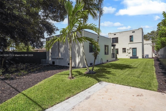 1145 SW 20th Ave, Miami, FL 33135 - back of property with a patio and stucco siding