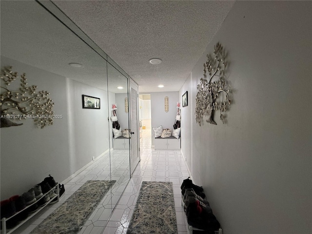 18011 Biscayne Blvd Unit 805, Aventura, FL 33160 - hallway featuring a textured ceiling, tile patterned flooring, and recessed lighting
