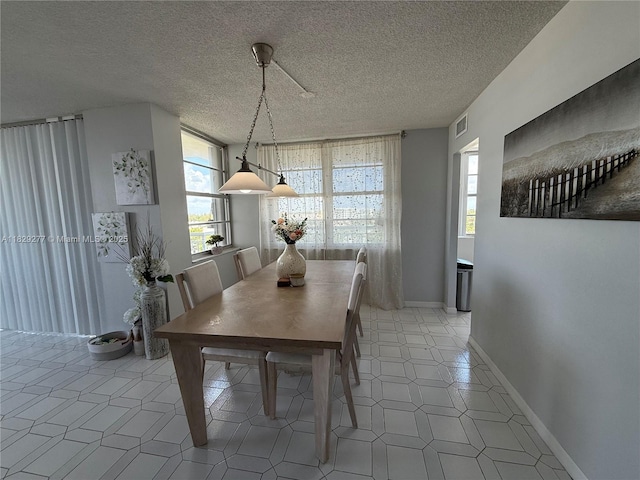 18011 Biscayne Blvd Unit 805, Aventura, FL 33160 - dining room featuring baseboards and a textured ceiling