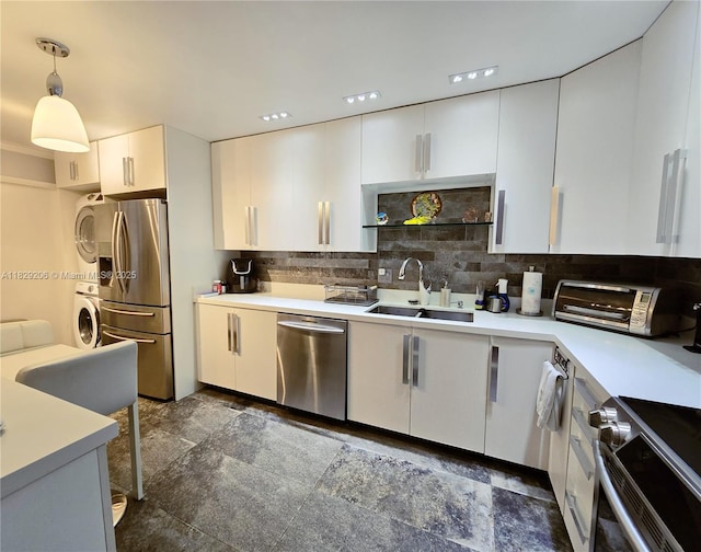 3071 N Course Dr Unit 107, Pompano Beach, FL 33069 - kitchen featuring stainless steel appliances, tasteful backsplash, white cabinetry, light countertops, and decorative light fixtures