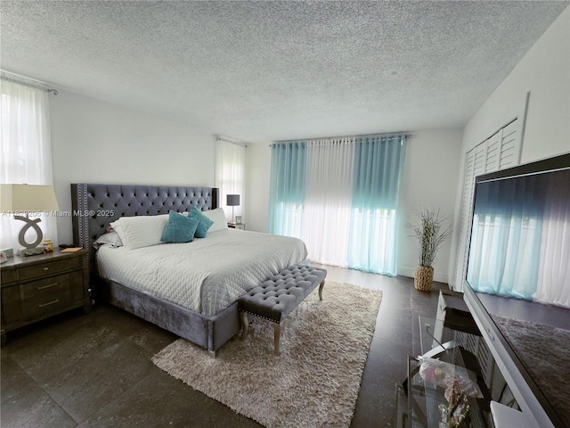 3071 N Course Dr Unit 107, Pompano Beach, FL 33069 - bedroom featuring multiple windows and a textured ceiling