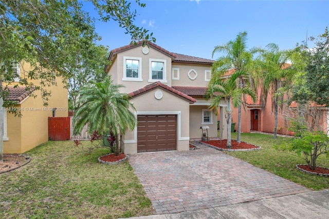1568 SE 20th Ter, Homestead, FL 33035 - mediterranean / spanish-style home with a tile roof, decorative driveway, stucco siding, and an attached garage