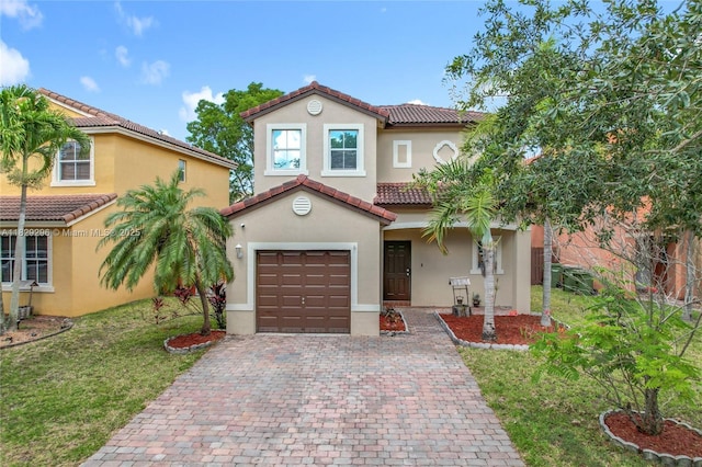 1568 SE 20th Ter, Homestead, FL 33035 - mediterranean / spanish-style house featuring a tile roof, decorative driveway, stucco siding, a garage, and a front lawn