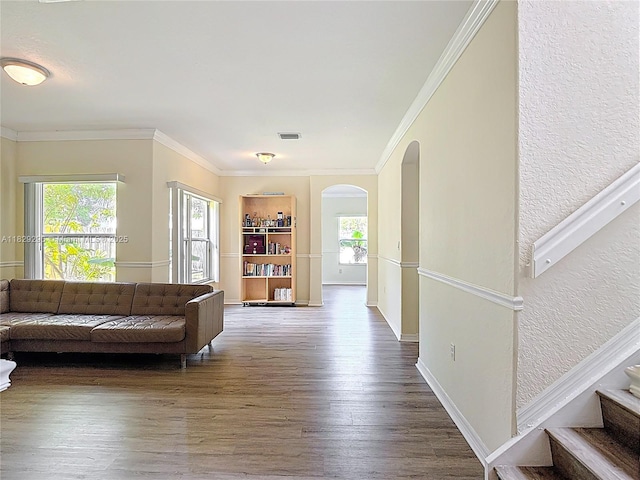 1568 SE 20th Ter, Homestead, FL 33035 - living area with arched walkways, wood finished floors, healthy amount of natural light, ornamental molding, and stairway