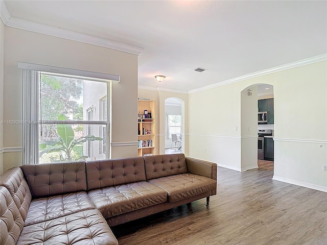 1568 SE 20th Ter, Homestead, FL 33035 - living room featuring arched walkways, crown molding, and wood finished floors