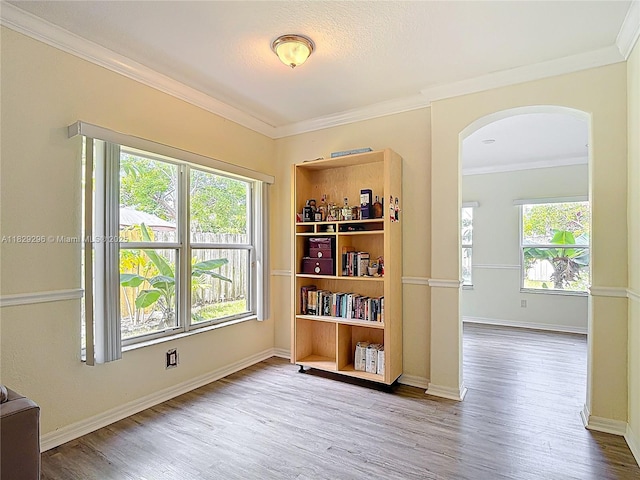 1568 SE 20th Ter, Homestead, FL 33035 - empty room with arched walkways, wood finished floors, and ornamental molding