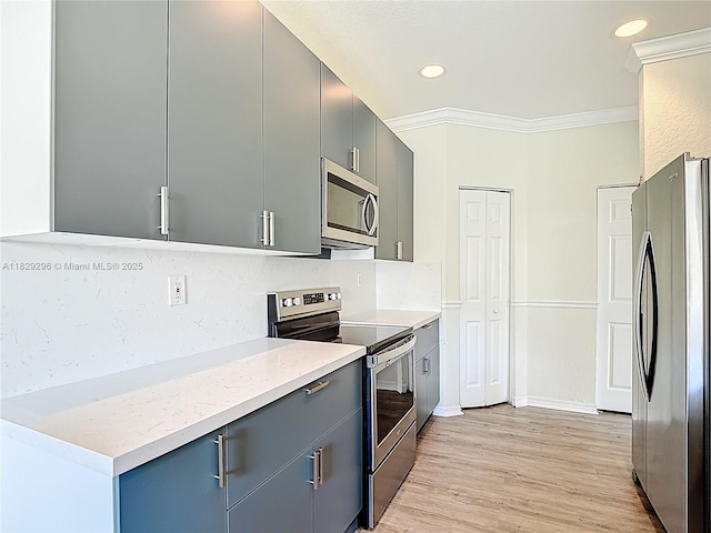 1568 SE 20th Ter, Homestead, FL 33035 - kitchen with appliances with stainless steel finishes, tasteful backsplash, light wood-style flooring, ornamental molding, and gray cabinetry