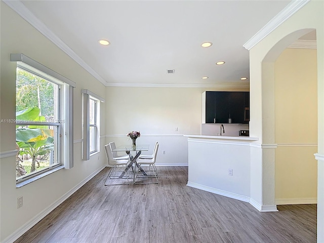 1568 SE 20th Ter, Homestead, FL 33035 - living area featuring arched walkways, light wood finished floors, recessed lighting, and crown molding