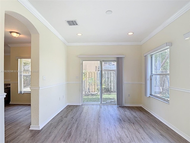 1568 SE 20th Ter, Homestead, FL 33035 - empty room with wood finished floors, arched walkways, ornamental molding, and recessed lighting