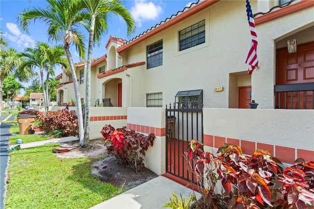 1507 Congressional Way Unit 1507, Deerfield Beach, FL 33442 - view of front of property featuring a tile roof, stucco siding, and a gate