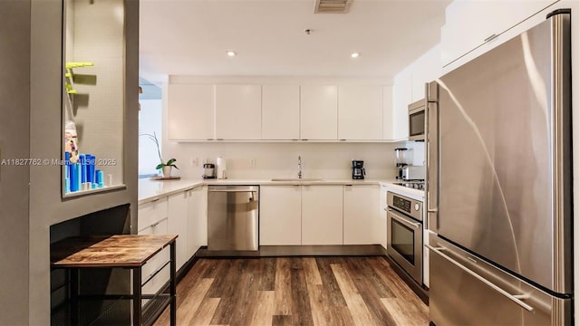 3250 NE 1st Ave Unit 1101, Miami, FL 33137 - kitchen with stainless steel appliances, light countertops, white cabinets, and recessed lighting