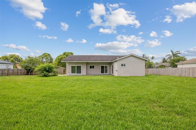 13225 SW 218th Ter, Miami, FL 33170 - back of property featuring a fenced backyard and stucco siding
