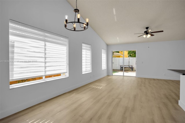 1611 Palermo Dr, Weston, FL 33327 - unfurnished living room featuring a chandelier, ceiling fan, light wood-type flooring, and high vaulted ceiling