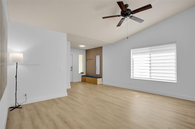 1611 Palermo Dr, Weston, FL 33327 - empty room with light wood-type flooring, ceiling fan, vaulted ceiling, and a textured ceiling