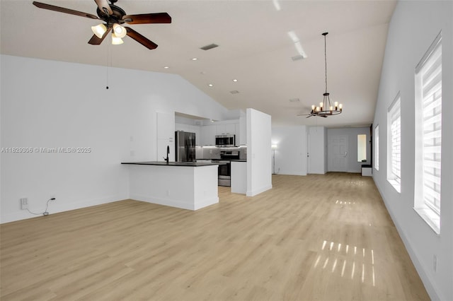 1611 Palermo Dr, Weston, FL 33327 - unfurnished living room with a chandelier, ceiling fan, light wood finished floors, and high vaulted ceiling