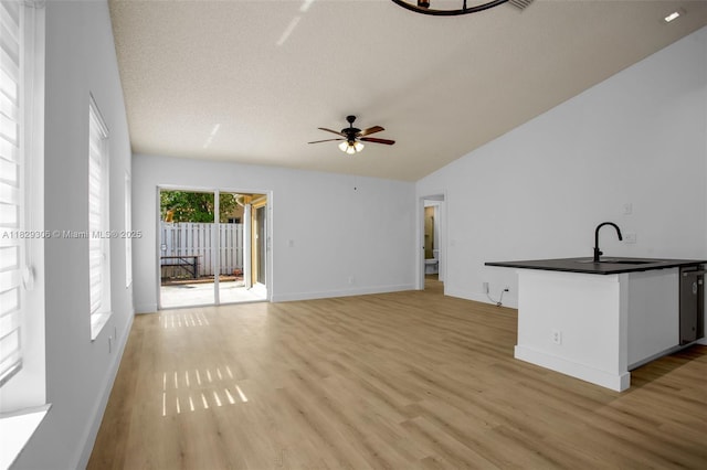 1611 Palermo Dr, Weston, FL 33327 - unfurnished living room with light wood-style flooring, ceiling fan, and a textured ceiling