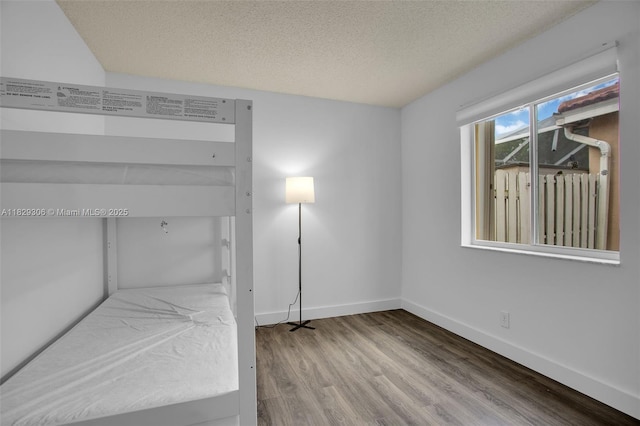 1611 Palermo Dr, Weston, FL 33327 - unfurnished bedroom with wood finished floors and a textured ceiling
