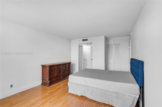 600 Three Islands Blvd Unit 310, Hallandale Beach, FL 33009 - bedroom with wood finished floors and a textured ceiling