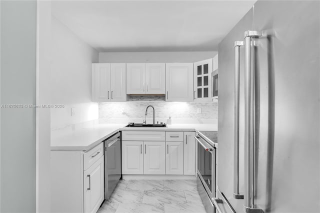 600 Three Islands Blvd Unit 310, Hallandale Beach, FL 33009 - kitchen with stainless steel appliances, light marble finish floors, white cabinets, decorative backsplash, and glass insert cabinets