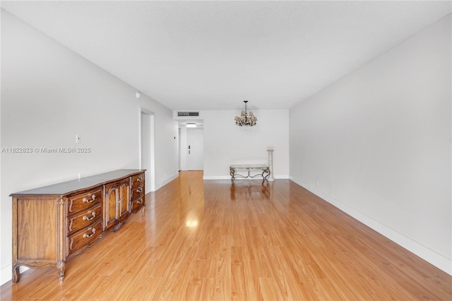 600 Three Islands Blvd Unit 310, Hallandale Beach, FL 33009 - empty room with a chandelier and light wood finished floors