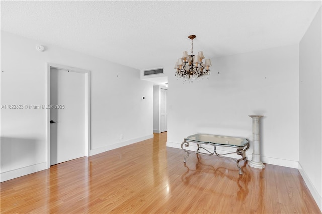 600 Three Islands Blvd Unit 310, Hallandale Beach, FL 33009 - unfurnished dining area with wood finished floors, a chandelier, and a textured ceiling