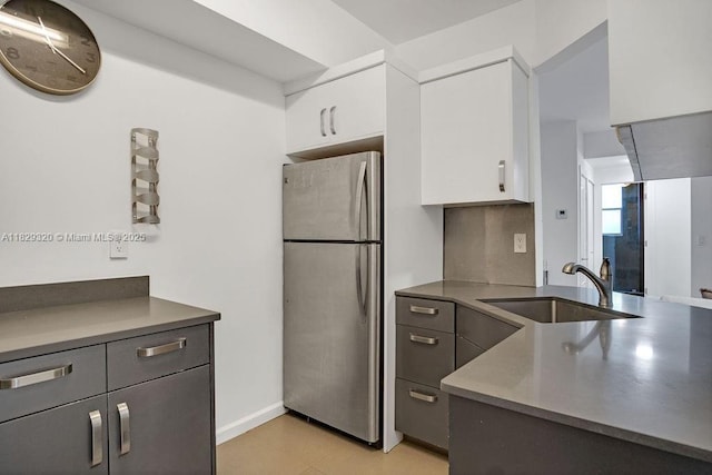 747 Michigan Ave Unit 201, Miami Beach, FL 33139 - kitchen featuring freestanding refrigerator, white cabinetry, and a peninsula